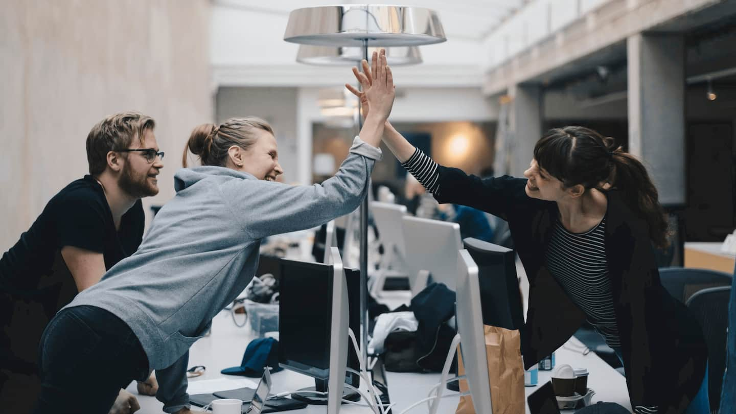 Two individuals high-five each other